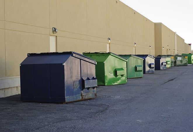 a yellow construction dumpster on a work site in Buford, GA